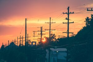 sunset over suburb power lines