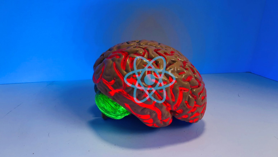 Photo of a plastic brain with React logo on it