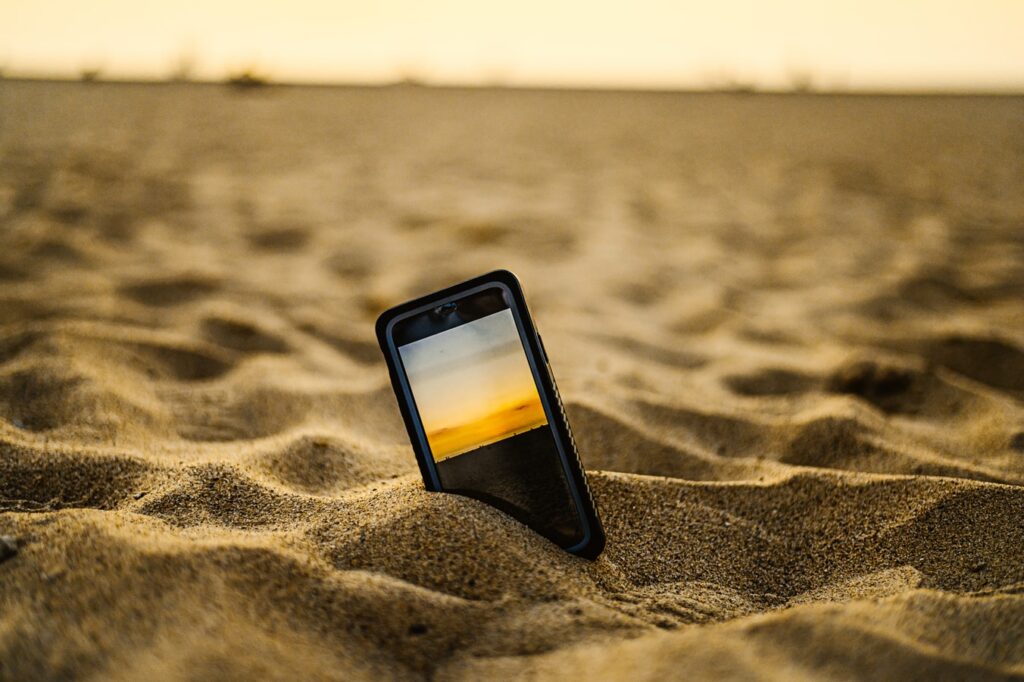 Phone in sand.