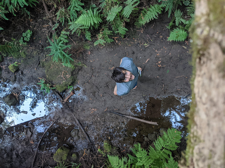 Man standing in marsh.
