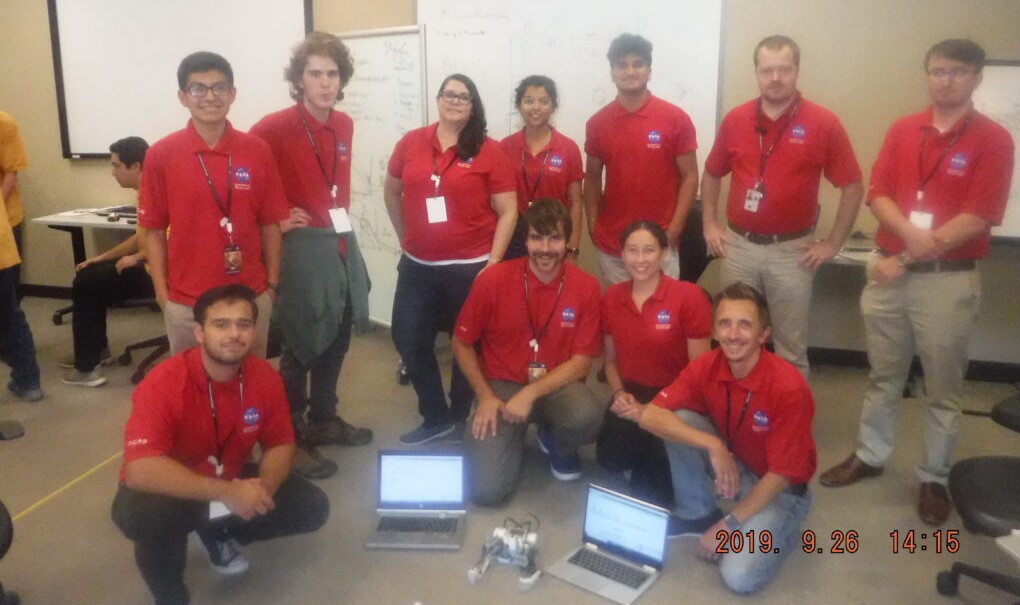 Group of people with red shirts.